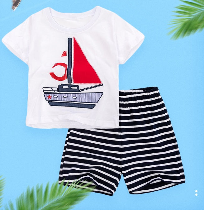 Child wearing a short-sleeve cotton shirt and matching elastic-waist shorts summer set