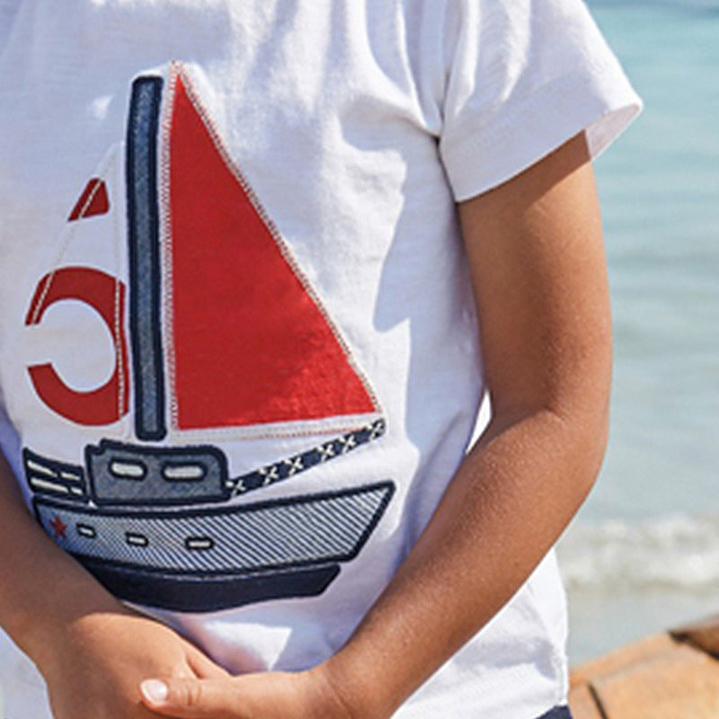 Child wearing a short-sleeve cotton shirt and matching elastic-waist shorts summer set