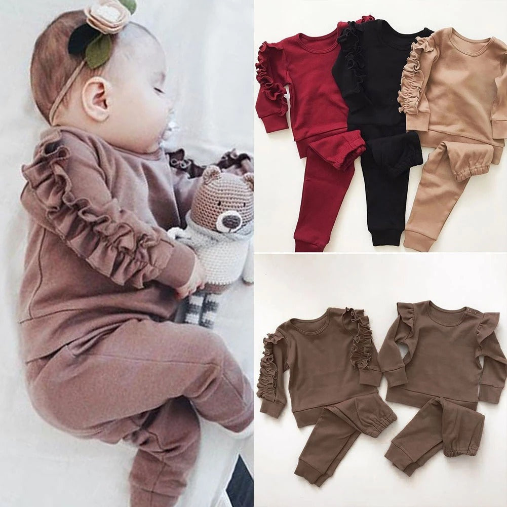 Newborn baby girl in ruffle sweatshirt and pants outfit