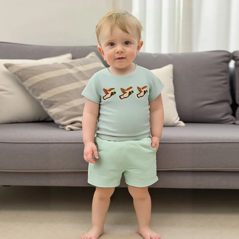 Baby boy summer outfit featuring short-sleeve embroidered fish/duck T-shirt and plaid or solid shorts for toddlers