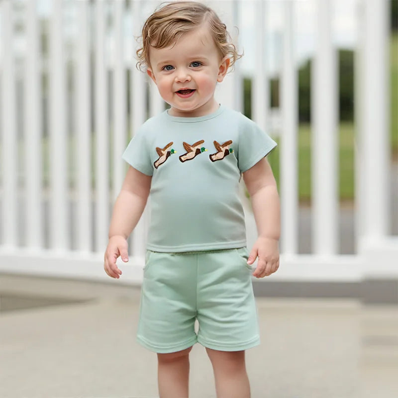 Baby boy summer outfit featuring short-sleeve embroidered fish/duck T-shirt and plaid or solid shorts for toddlers