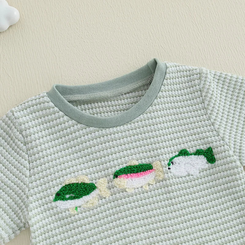 Baby boy summer outfit featuring short-sleeve embroidered fish/duck T-shirt and plaid or solid shorts for toddlers
