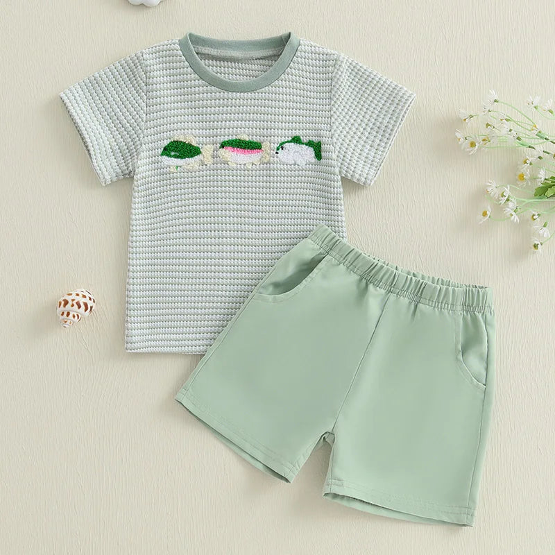 Baby boy summer outfit featuring short-sleeve embroidered fish/duck T-shirt and plaid or solid shorts for toddlers