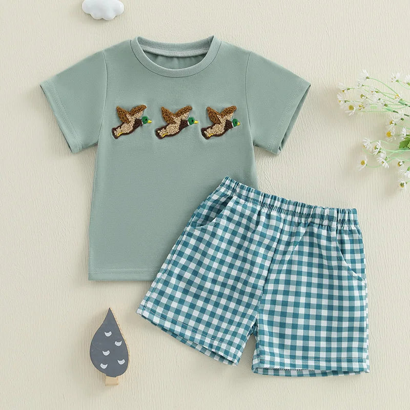 Baby boy summer outfit featuring short-sleeve embroidered fish/duck T-shirt and plaid or solid shorts for toddlers